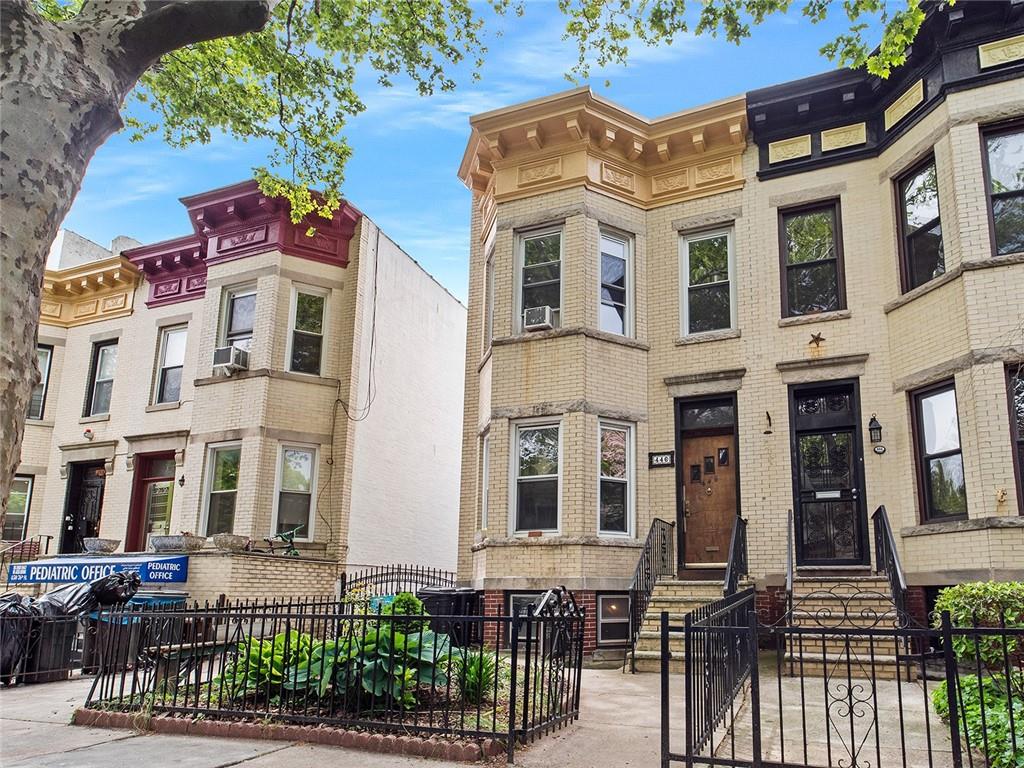 446 76th Street Brooklyn, NY 11209 - Photo 2 of 35 a front view of a residential apartment building with a yard