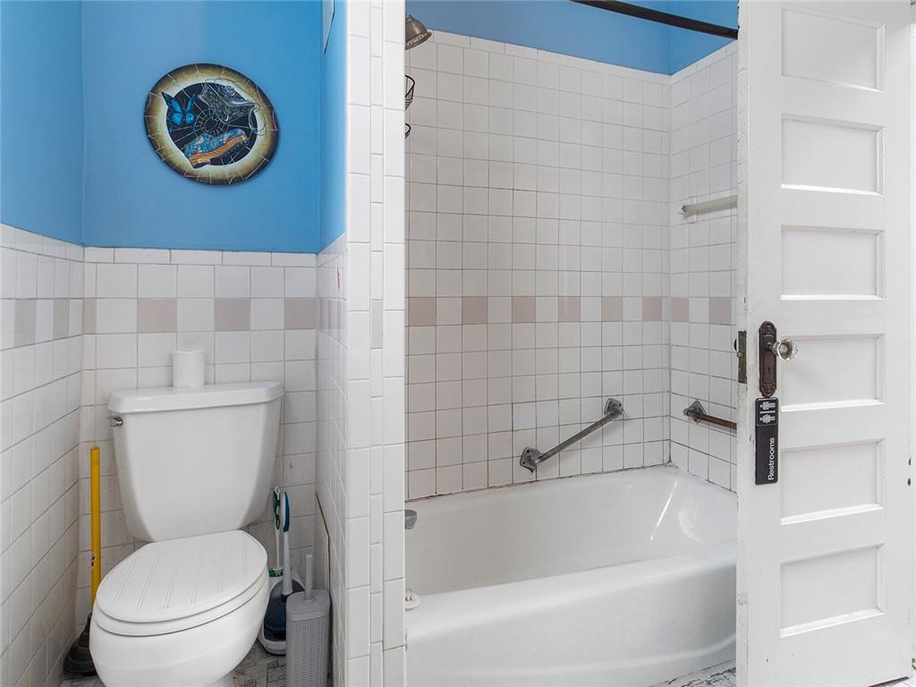 446 76th Street Brooklyn, NY 11209 - Photo 21 of 35 a bathroom with a toilet and a bathtub