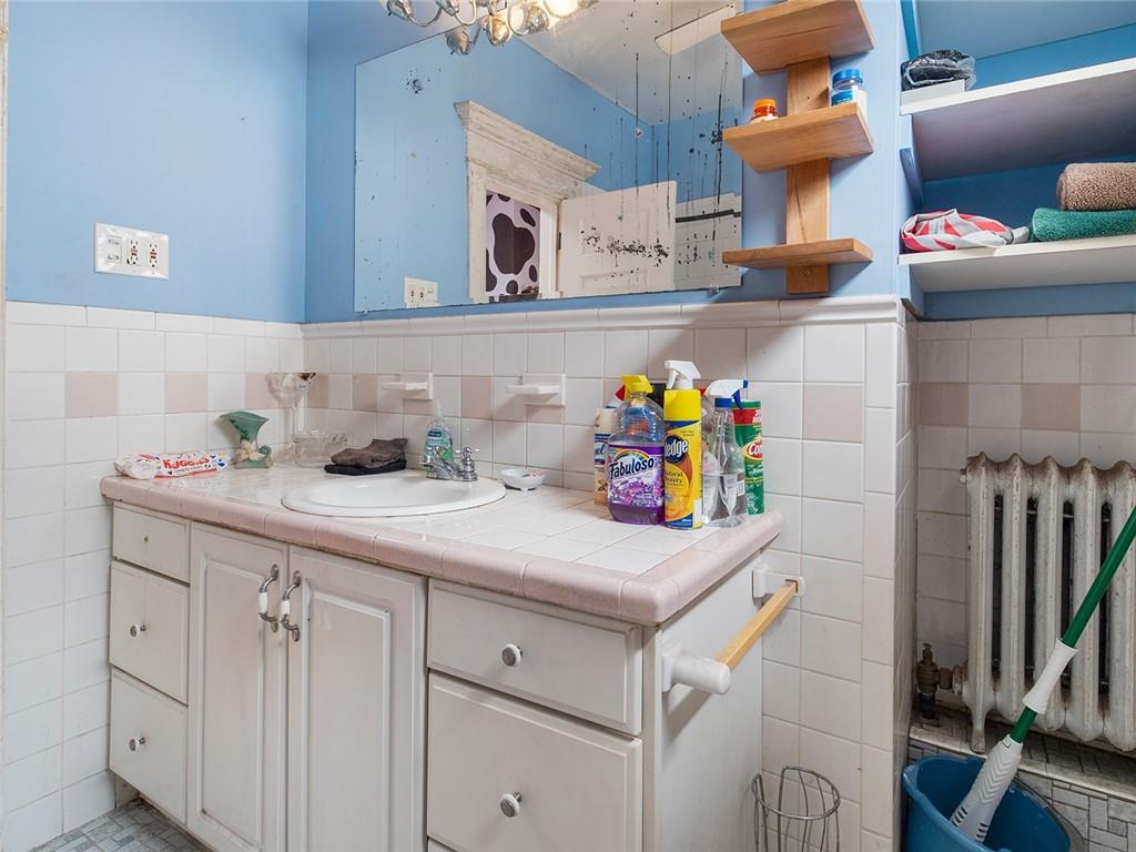 446 76th Street Brooklyn, NY 11209 - Photo 22 of 35 a kitchen with a sink and cabinets