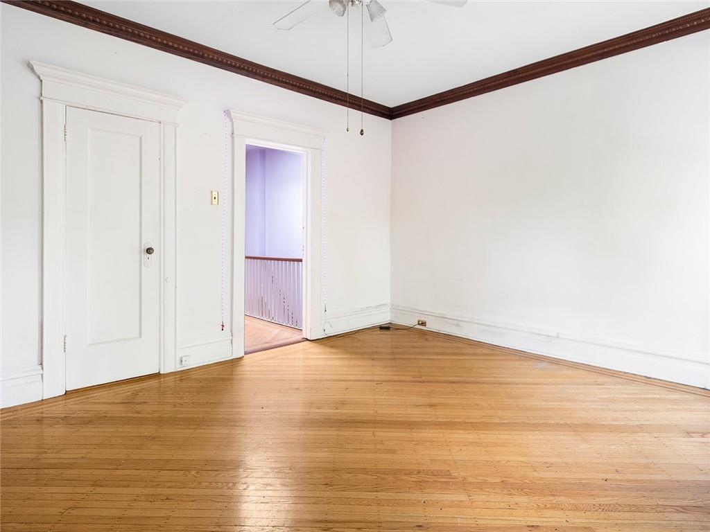 446 76th Street Brooklyn, NY 11209 - Photo 24 of 35 a view of an empty room with chandelier fan and wooden floor