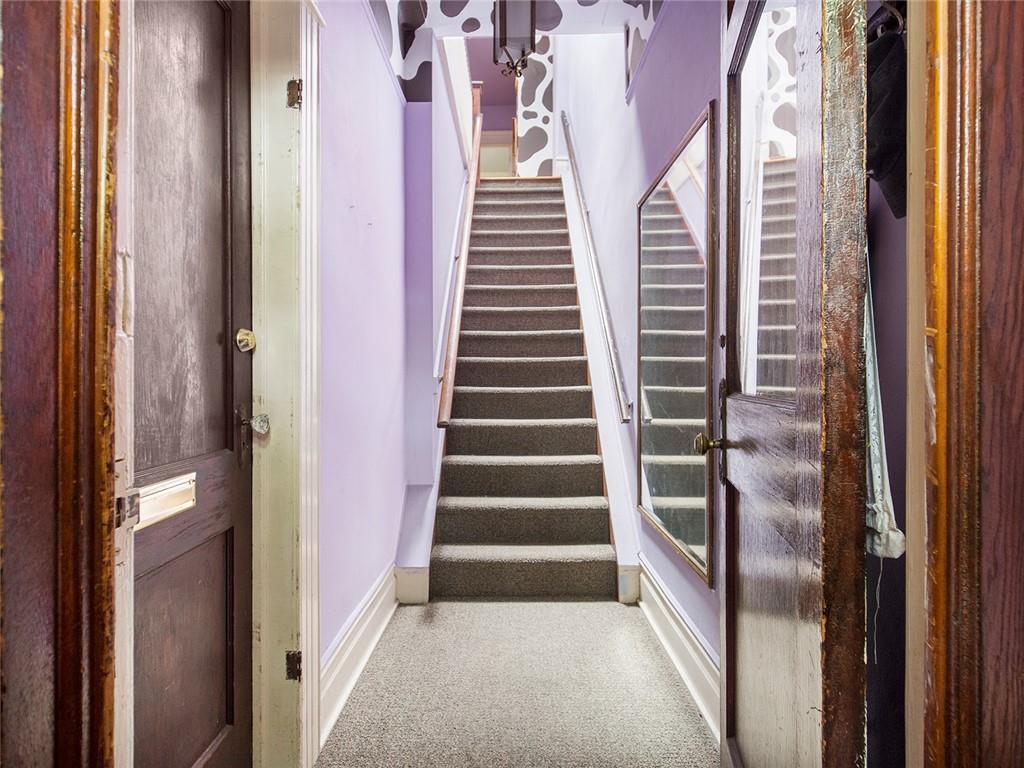 446 76th Street Brooklyn, NY 11209 - Photo 26 of 35 a view of a hallway with windows and stairs