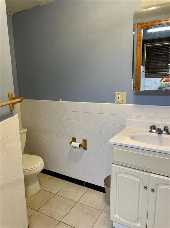 446 76th Street Brooklyn, NY 11209 - Photo 31 of 35 a bathroom with a sink a toilet and a mirror