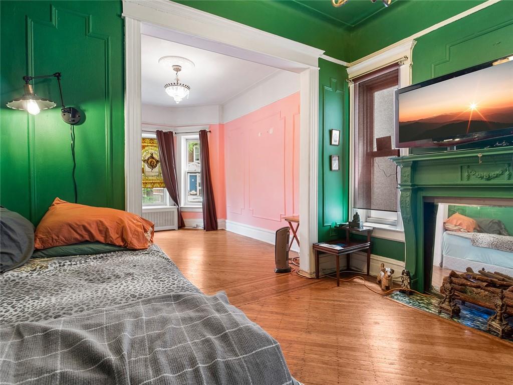 446 76th Street Brooklyn, NY 11209 - Photo 7 of 35 a bedroom with furniture and a large window