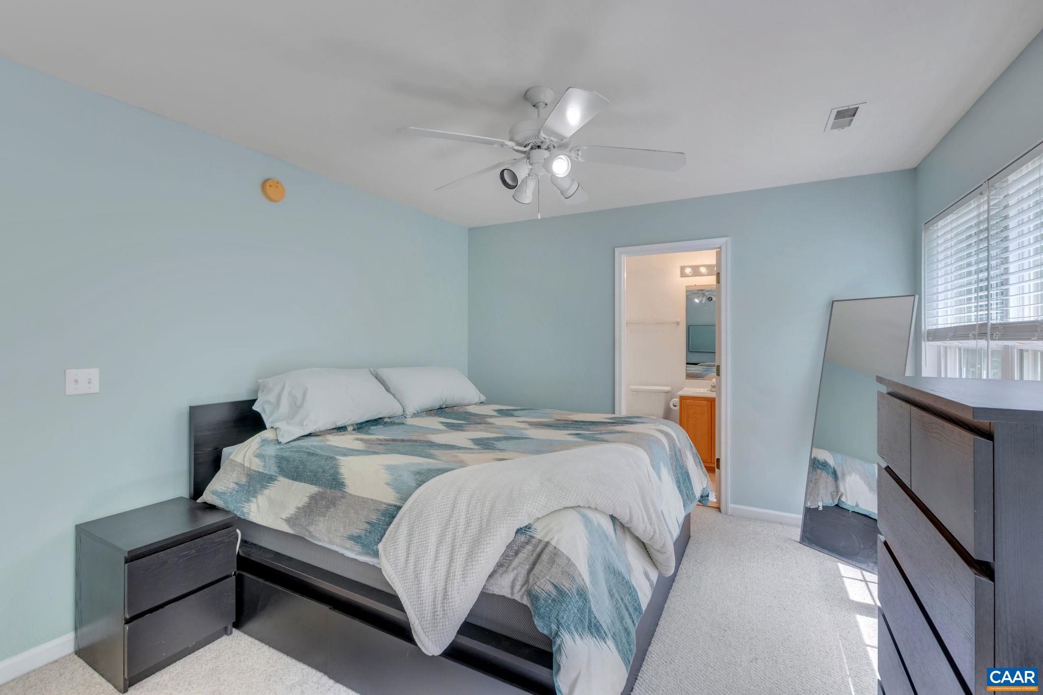 2 Riverside Drive Palmyra, VA 22963 - Photo 14 of 36 a bedroom with a large bed and a chandelier