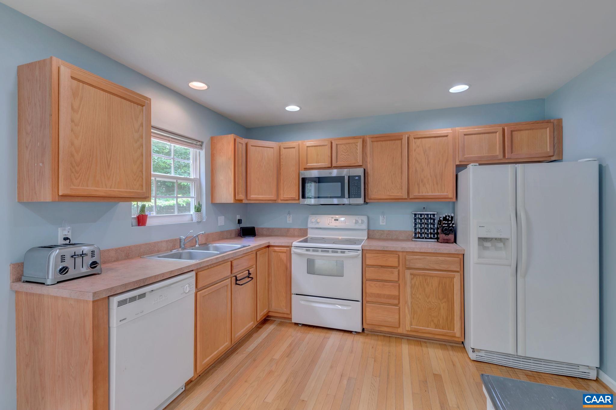 2 Riverside Drive Palmyra, VA 22963 - Photo 9 of 36 a kitchen with a refrigerator a sink and cabinets