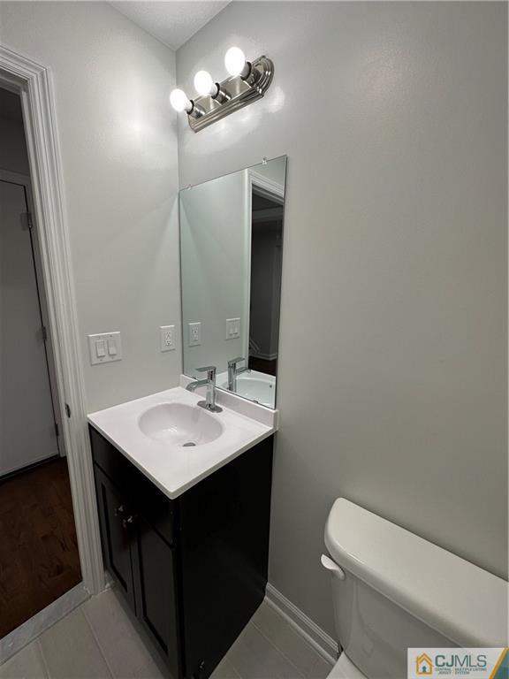 3703 Hana Road Edison, NJ 08817 - Photo 4 of 55 a bathroom with a sink a toilet and mirror