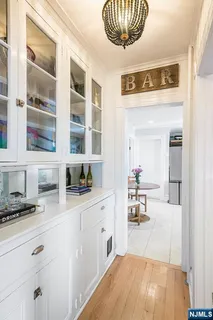 a kitchen with granite countertop a sink cabinets and stainless steel appliances
