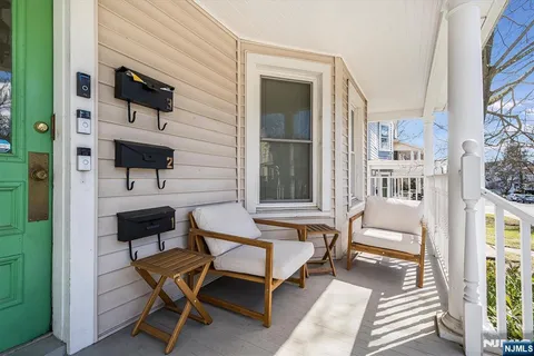 a balcony with table and chairs