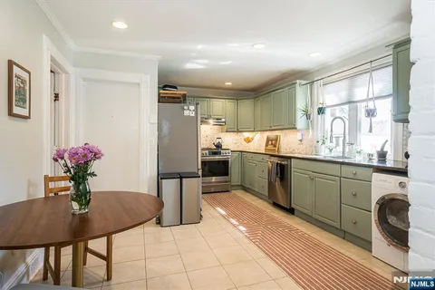 a kitchen with a refrigerator and a sink