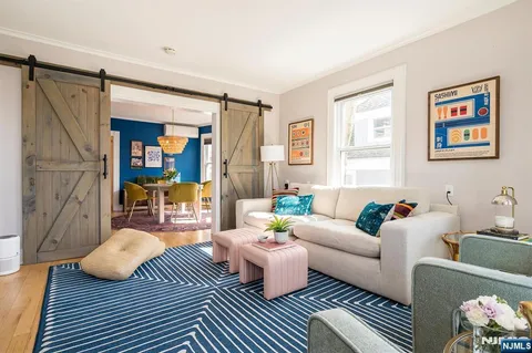 a living room with furniture wooden floor and a table