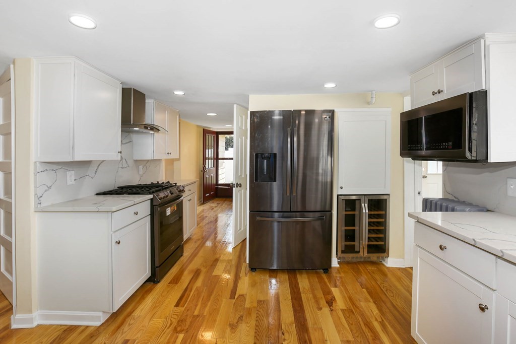 266 Webster Street Worcester, MA 01603 - Photo 16 of 42 a kitchen with granite countertop a refrigerator stove and oven