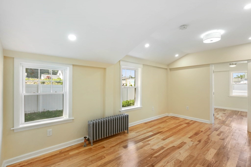 266 Webster Street Worcester, MA 01603 - Photo 19 of 42 a view of empty room with wooden floor and fan