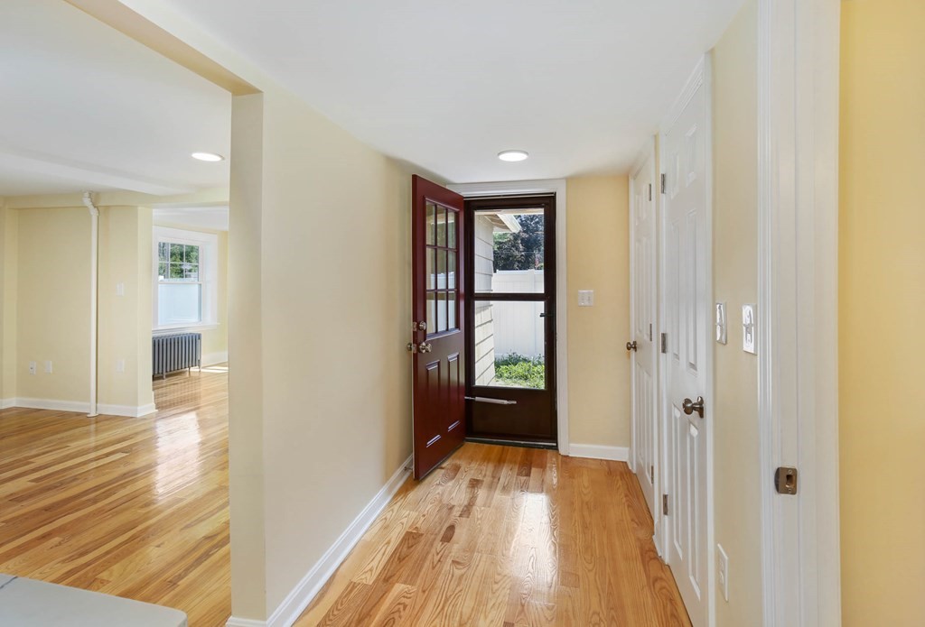 266 Webster Street Worcester, MA 01603 - Photo 24 of 42 a view of a hallway with wooden floor and a bathroom