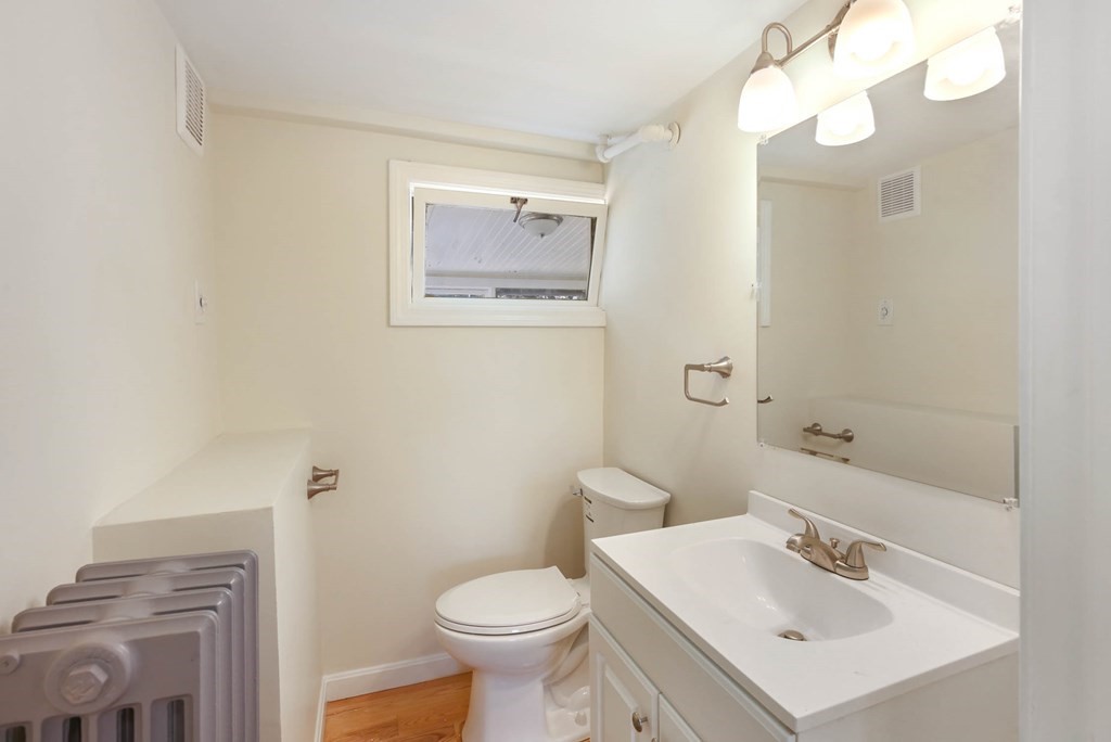 266 Webster Street Worcester, MA 01603 - Photo 26 of 42 a bathroom with a sink mirror and toilet