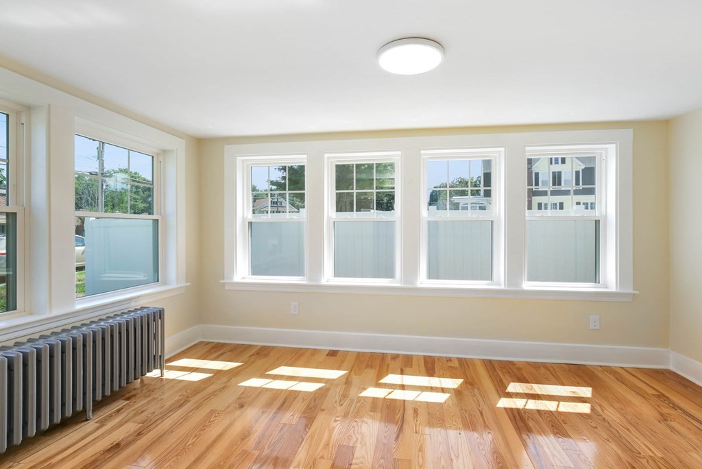 266 Webster Street Worcester, MA 01603 - Photo 28 of 42 a view of an empty room with wooden floor and a window