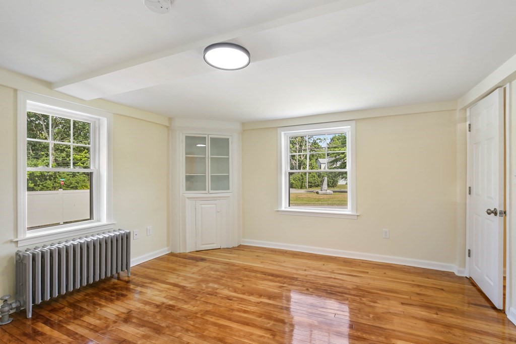 266 Webster Street Worcester, MA 01603 - Photo 30 of 42 a view of an empty room with wooden floor and a window
