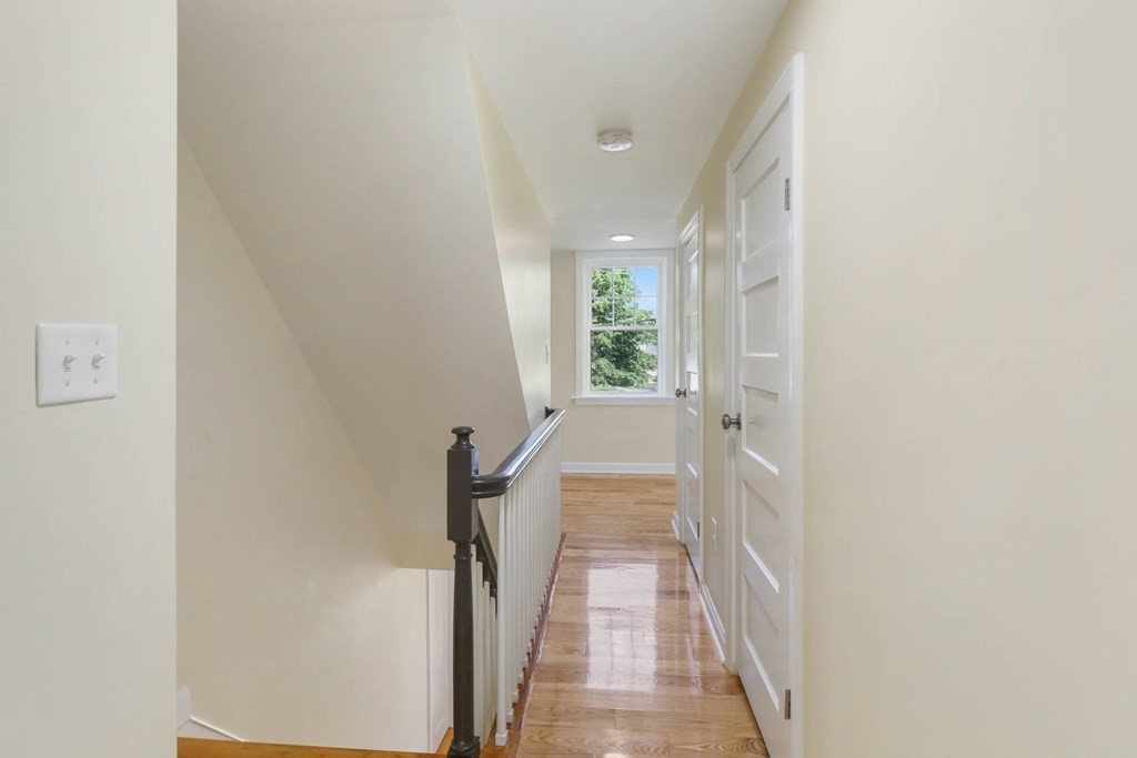266 Webster Street Worcester, MA 01603 - Photo 32 of 42 a view of a hallway with wooden floor and a bathroom