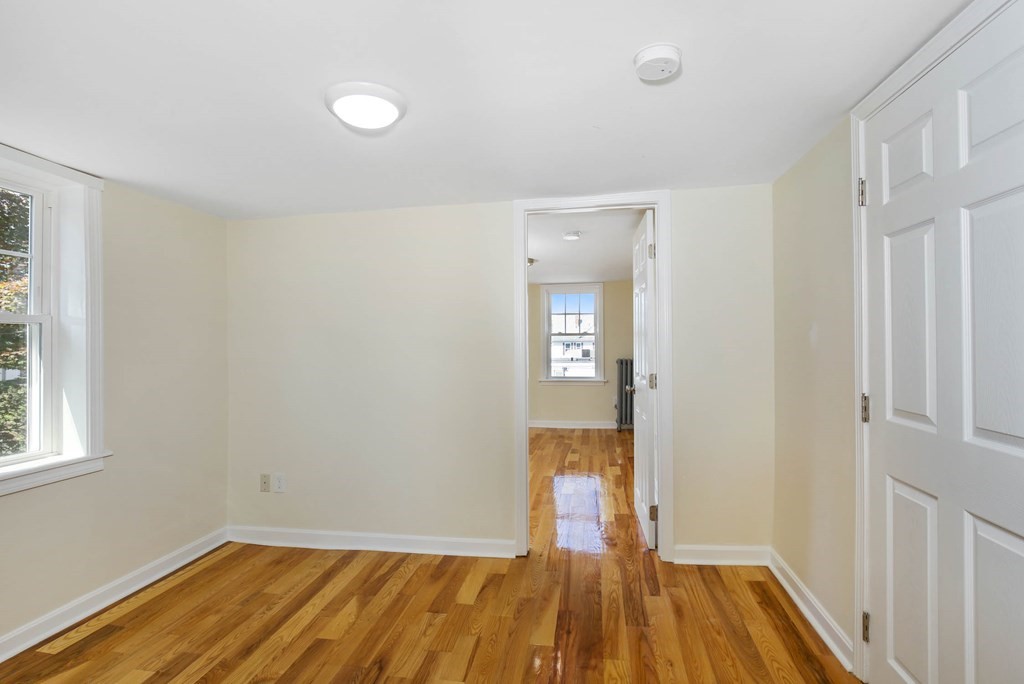266 Webster Street Worcester, MA 01603 - Photo 33 of 42 a view of empty room with wooden floor and fan