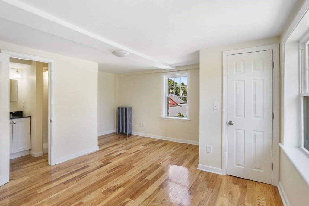 266 Webster Street Worcester, MA 01603 - Photo 36 of 42 wooden floor in an empty room with a window