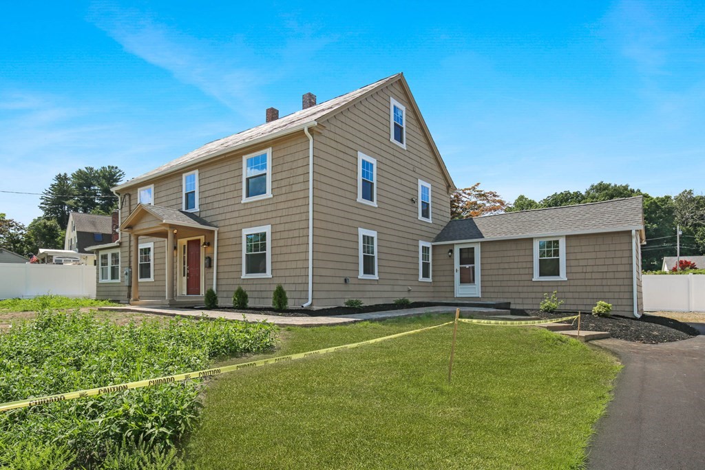 266 Webster Street Worcester, MA 01603 - Photo 9 of 42 a front view of house with yard and trees in the background