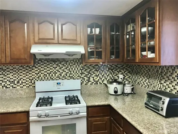 a kitchen with a sink and a stove top oven