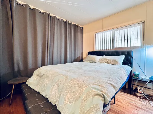 a large bed sitting in a bedroom next to a window
