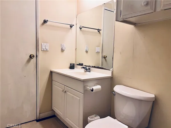 a bathroom with a sink a toilet a mirror and shower