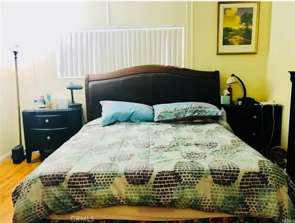 a bedroom with a bed and window