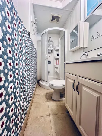 a bathroom with a toilet and a shower curtain