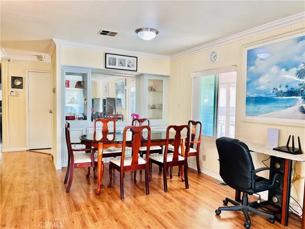 a dining room with furniture and wooden floor