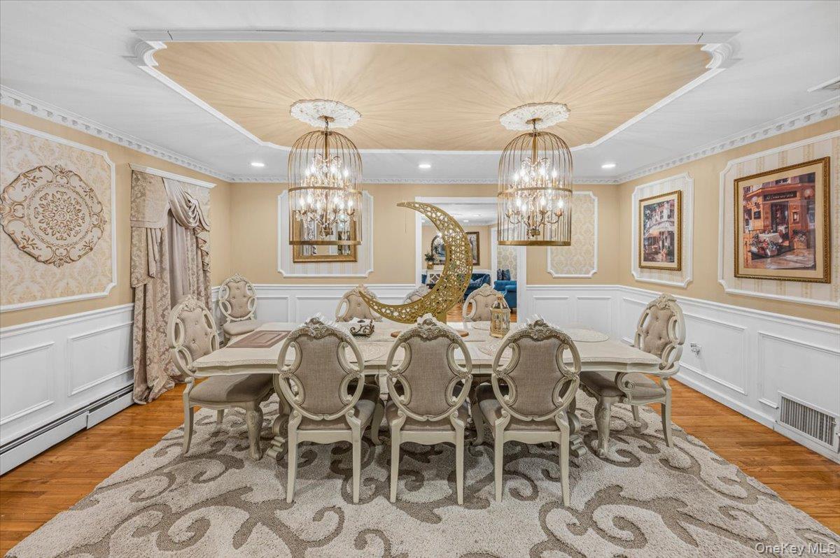626 Caledonia Road Dix Hills, NY 11746 - Photo 18 of 49 a view of a dining room with furniture a chandelier and wooden floor