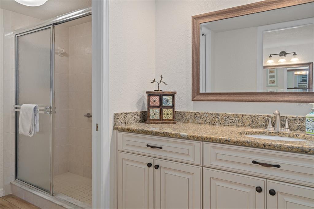 8211 Brent Street, Unit 847 Port Richey, FL 34668 - Photo 24 of 29 a bathroom with a granite countertop sink and a mirror