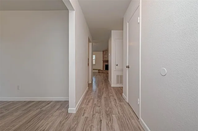 a view of a room with wooden floor