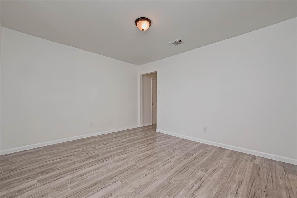 5503 Lynngate Drive Spring, TX 77373 - Photo 6 of 15 a view of an empty room with wooden floor