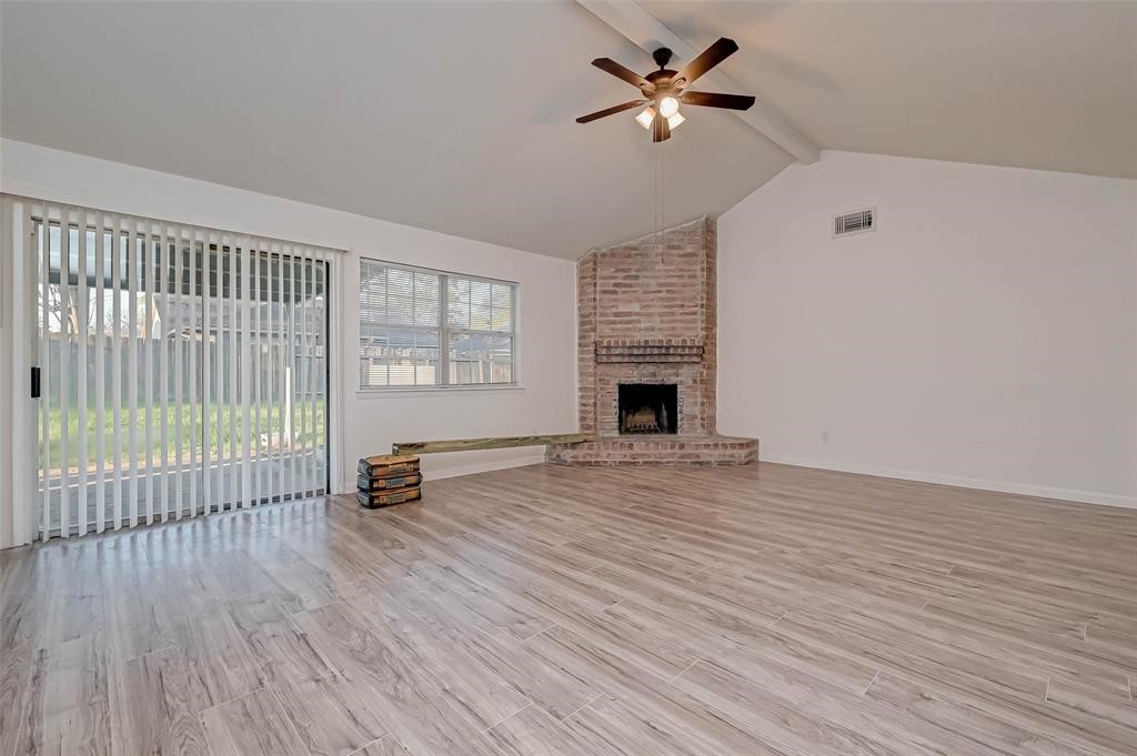 5503 Lynngate Drive Spring, TX 77373 - Photo 7 of 15 wooden floor in an empty room with a fireplace