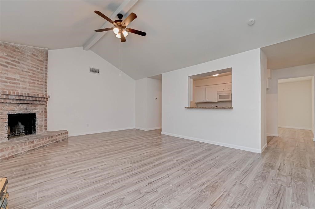 5503 Lynngate Drive Spring, TX 77373 - Photo 8 of 15 wooden floor in an empty room with a fireplace