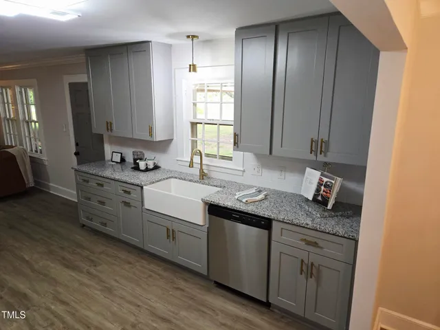 a kitchen with stainless steel appliances granite countertop a sink stove and cabinets