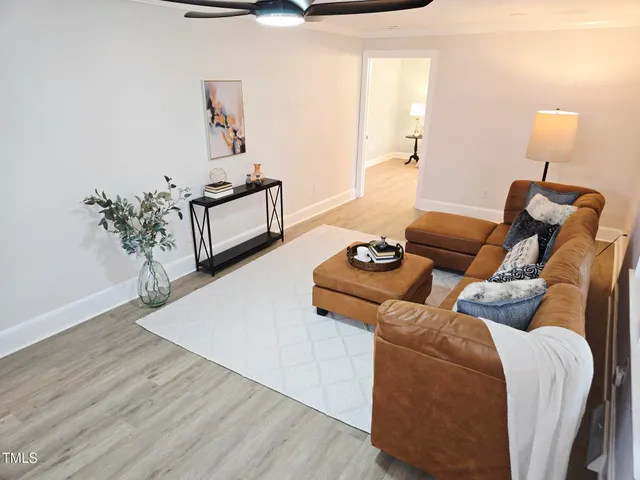 a living room with furniture and wooden floor