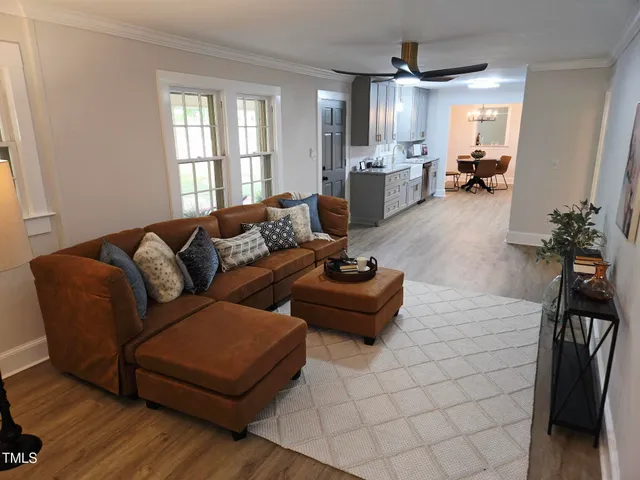 a living room with furniture rug and a window