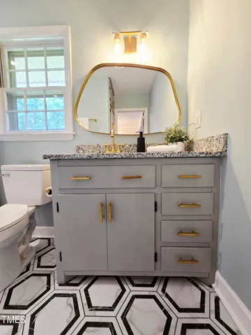 a kitchen with a sink cabinets and wooden floor