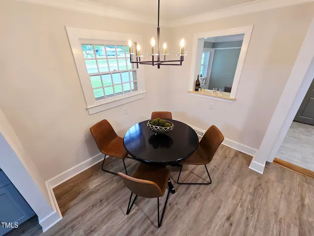 a view of room with window and wooden floor