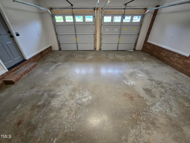 a view of a green field with wooden fence