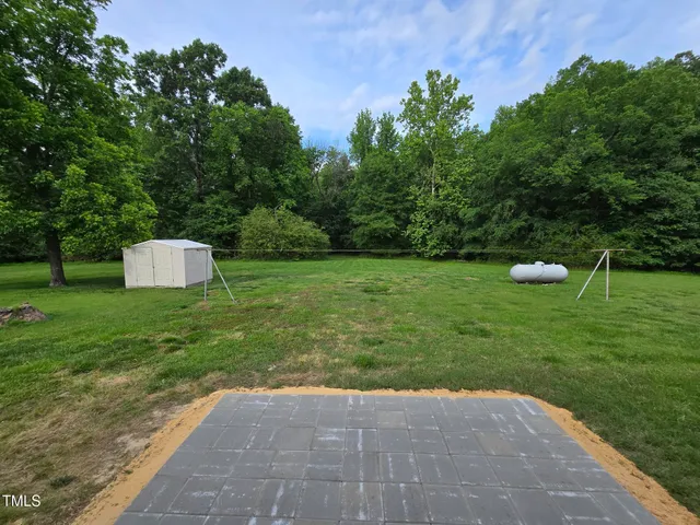 a view of backyard with trampoline