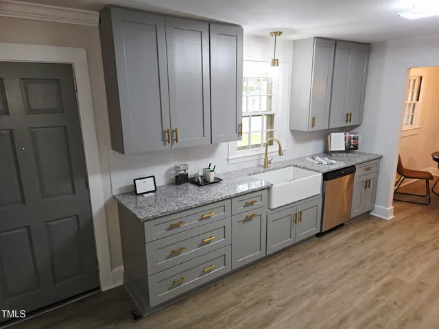 a spacious bathroom with a granite countertop sink and a mirror