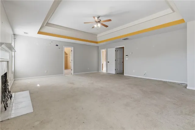 a view of a livingroom with a ceiling fan and window