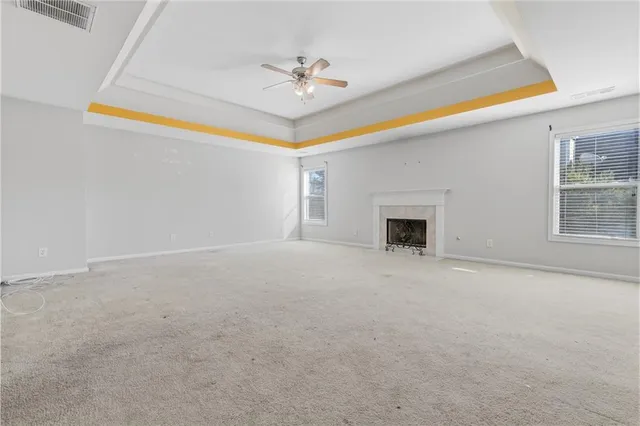 a view of a livingroom with a ceiling fan and window