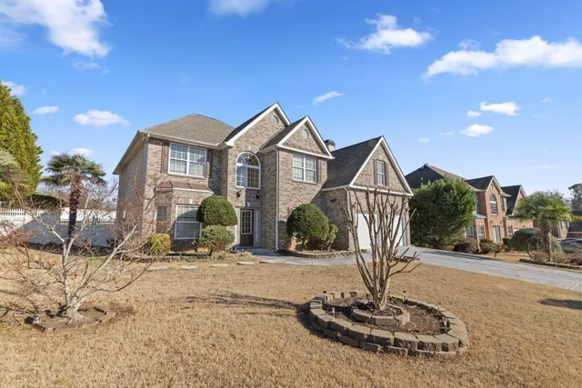 a front view of a house with garden