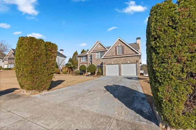a front view of a house with a yard and garage