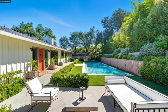a view of a chairs and table in patio with potted plants