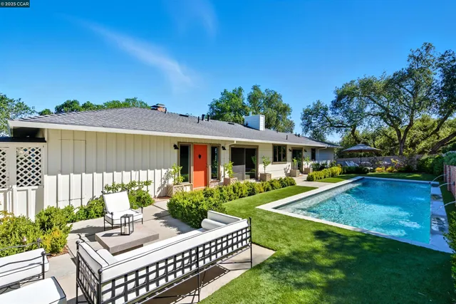a view of a patio with table and chairs and potted plants